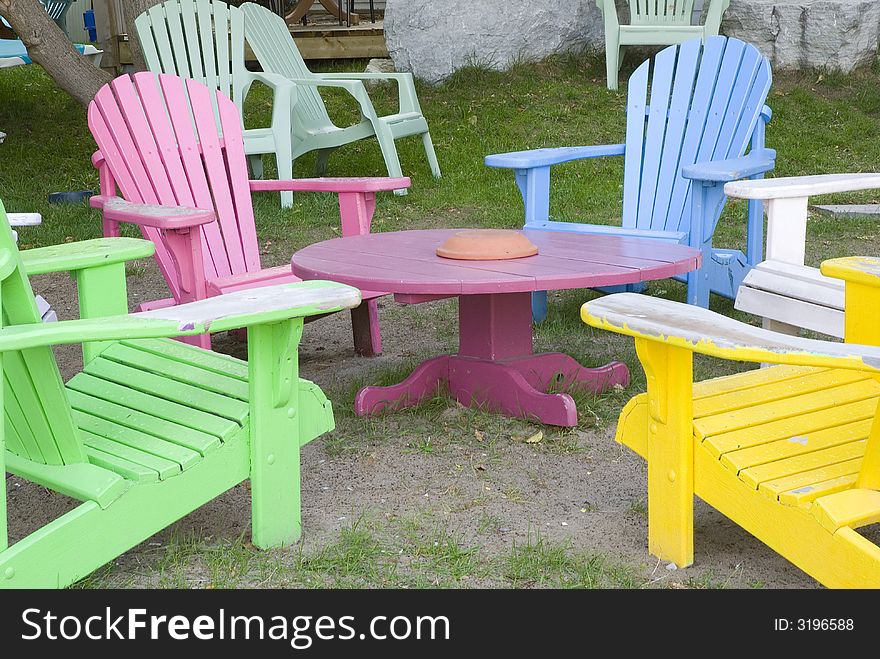 Multi colored wooden deck chairs in outdoor cafe