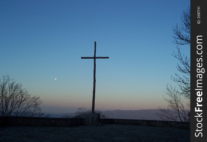 Cross in the sunset with the moon. Cross in the sunset with the moon