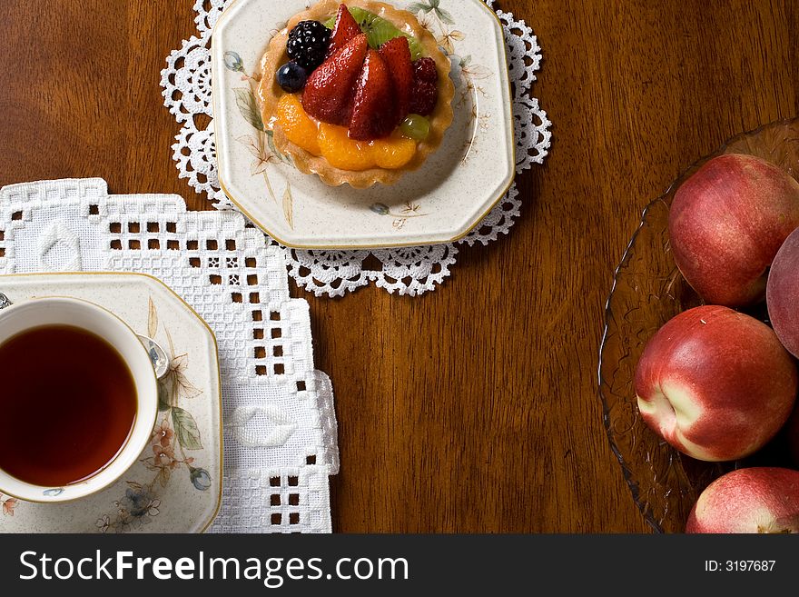 Top view of tea cup and fruit cake. Top view of tea cup and fruit cake