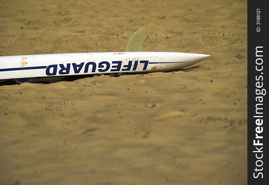 A lifeguard rescue board on the sand
