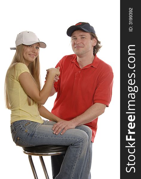 A man in black cap is holding girl's hand who is wearing sport clothes. A man in black cap is holding girl's hand who is wearing sport clothes