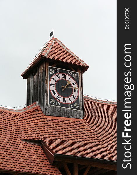 A tower with clock on and red roof. A tower with clock on and red roof.