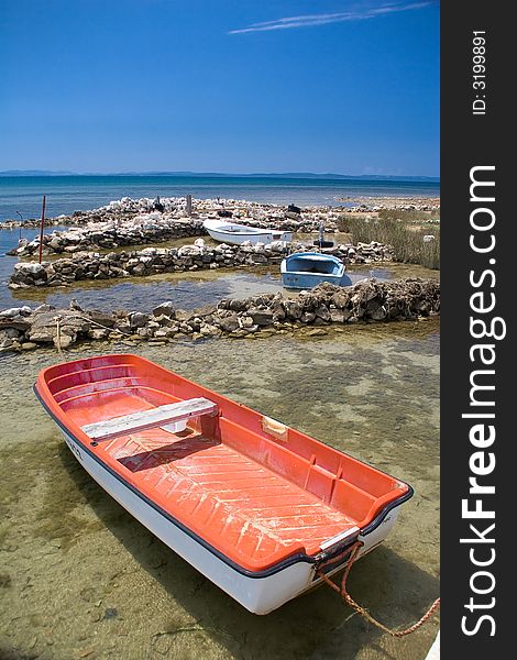 Red boat in the blue sea with blue sky