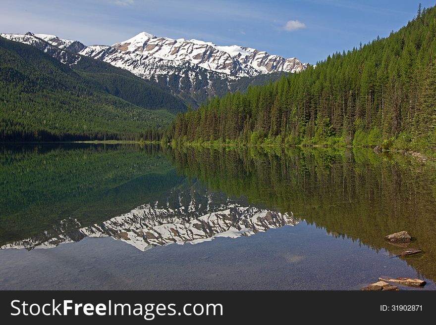 This image of the reflection of the snowy mountain in the water was taken at Stanton Lake in the Great Bear Wilderness of NW Montana. This image of the reflection of the snowy mountain in the water was taken at Stanton Lake in the Great Bear Wilderness of NW Montana.