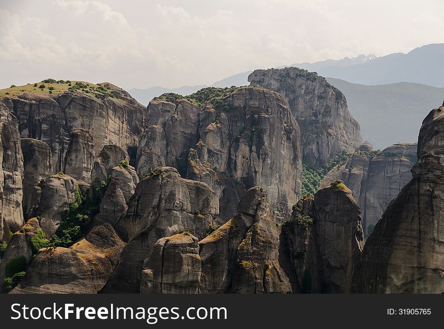 Natural formations in Greece at mountain area famous for medieval monasteries built on top of hard reachable rocks. Natural formations in Greece at mountain area famous for medieval monasteries built on top of hard reachable rocks.