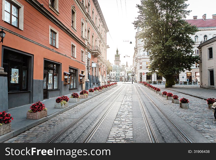 Old street in center of Lviv, Ukraine with flowers and tram line