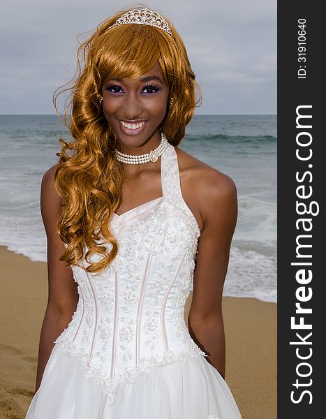 Stunning young bride at the beach in her wedding dress radiating joy. Stunning young bride at the beach in her wedding dress radiating joy.