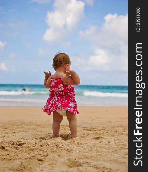 Baby girl on beach in Phuket enjoying herself. Baby girl on beach in Phuket enjoying herself