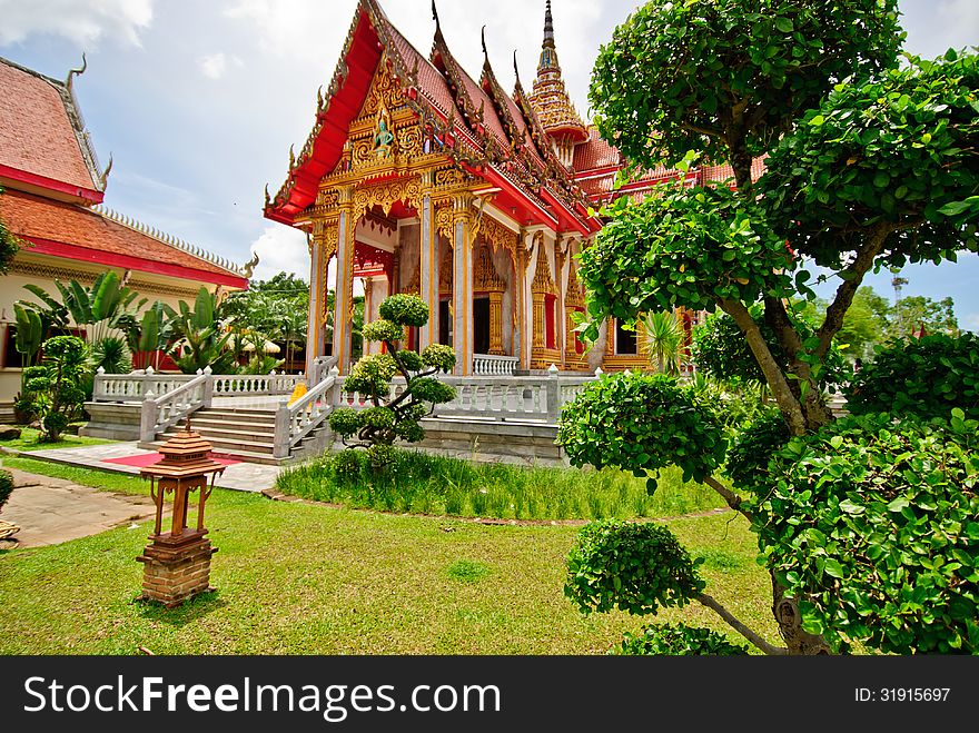 The Ubosot Sanctuary Hall with its steeply pitched, gabled roofs, chofah ornaments, and gilded spire. The Ubosot Sanctuary Hall with its steeply pitched, gabled roofs, chofah ornaments, and gilded spire.