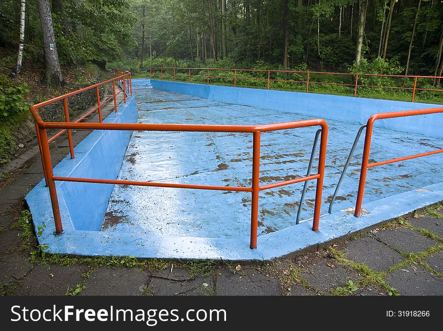 Drained swimming pool in the forest