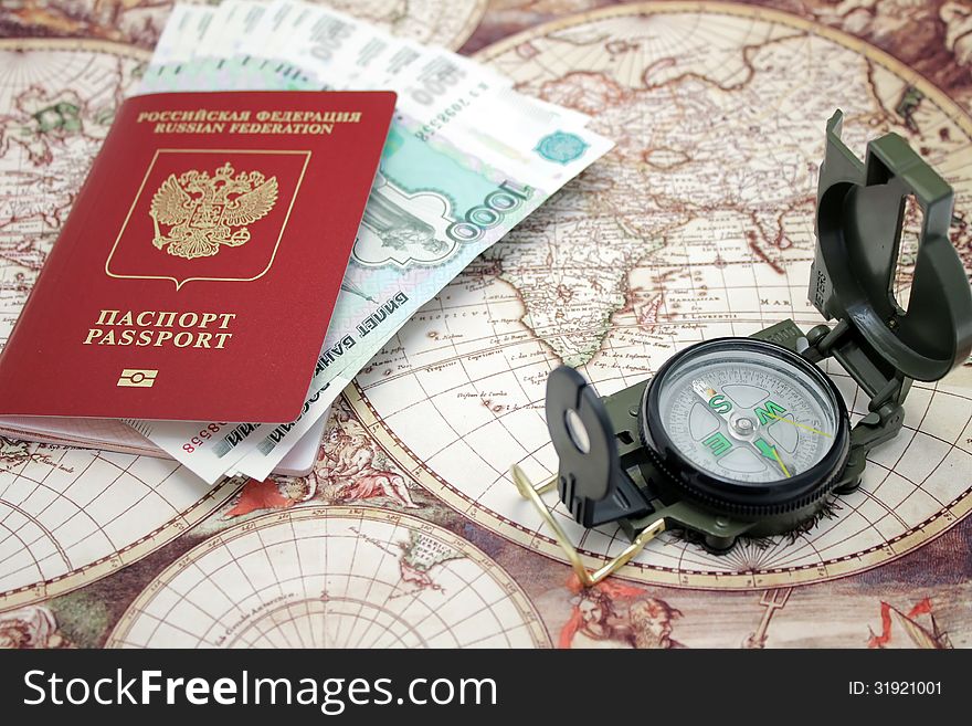 Passport, money and compass. background of the map of the world