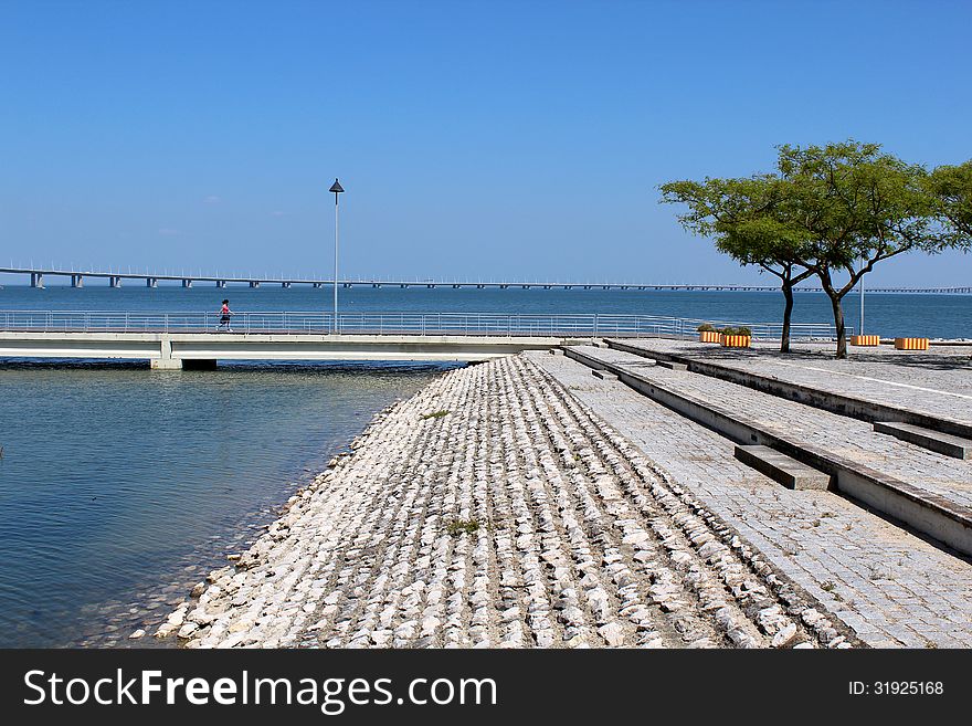 Parque das Nações (place of Expo 98) footpath and famous Vasco da Gama bridge in the background. Lisbon, Portugal. Parque das Nações (place of Expo 98) footpath and famous Vasco da Gama bridge in the background. Lisbon, Portugal.