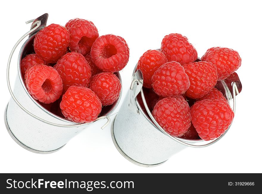 Arrangement of Tin Buckets with Perfect Ripe Raspberries isolated on white background. Arrangement of Tin Buckets with Perfect Ripe Raspberries isolated on white background