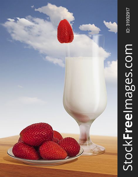 Plateful of strawberries with glass of milk, isolated with clipping path.