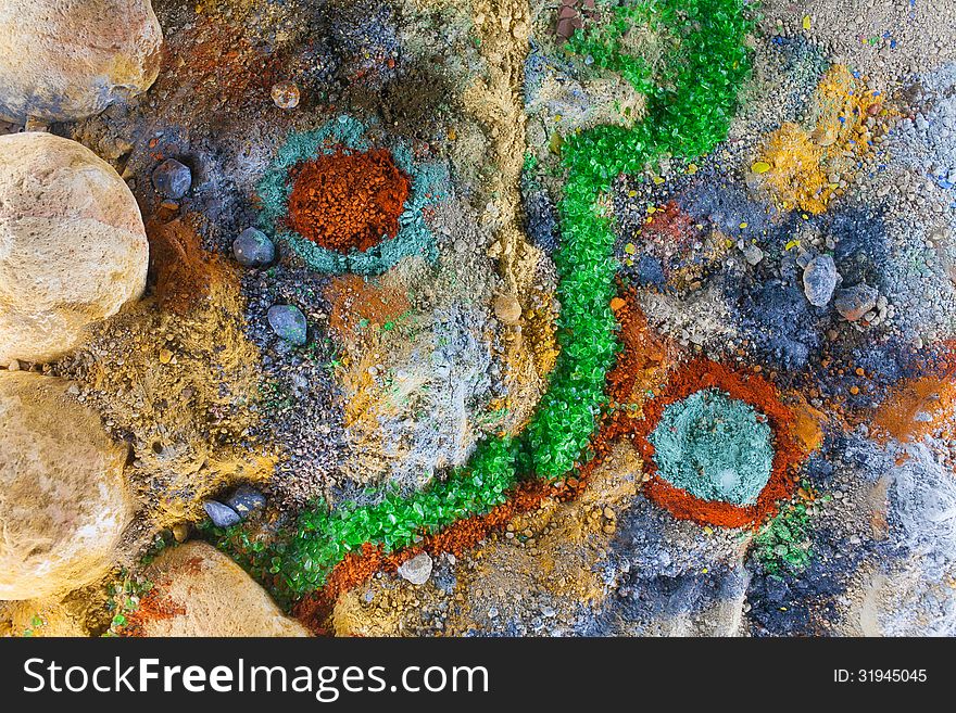 Close up on an abstract composition made by multicolored sand and pebbles. Close up on an abstract composition made by multicolored sand and pebbles