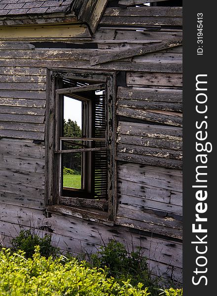 Abandon broken window on neglected wooden house