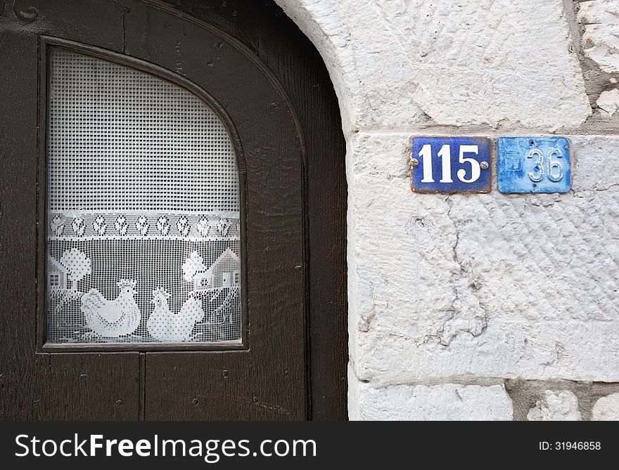 Vintage window with curtains on white brick wall. Belgium