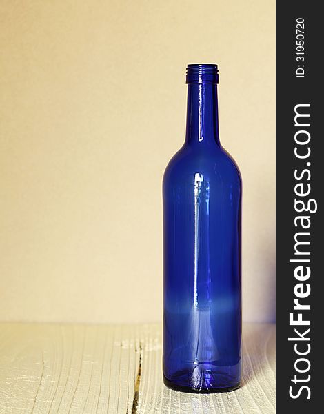 Wine bottle on wood table with wall background