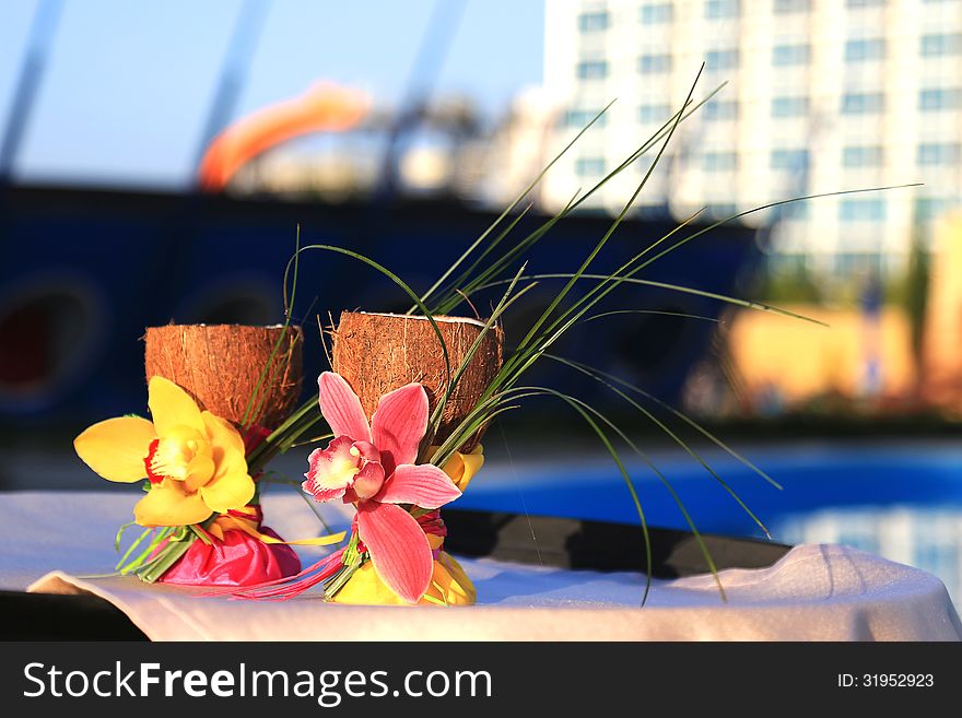 Two glasses of coconut decorated with orchids