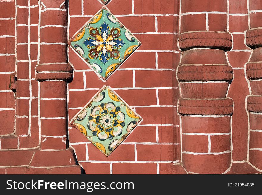 Detailed red brick wall fragment of ancient Russian Orthodox Church in Yaroslavl city with traditional ceramic tile decoration. Detailed red brick wall fragment of ancient Russian Orthodox Church in Yaroslavl city with traditional ceramic tile decoration