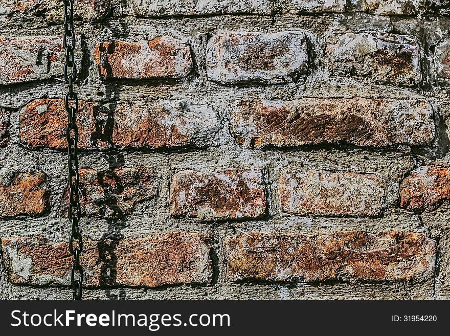 Medieval fortress antique brick rampart with chain, detail. Medieval fortress antique brick rampart with chain, detail.