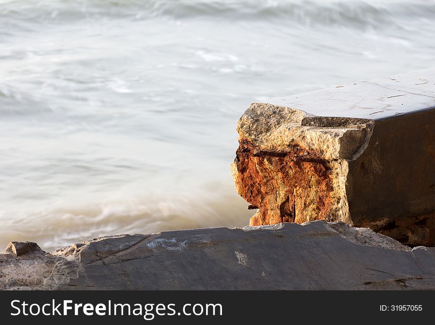 Broken Cement wall from sea wave iron Rust