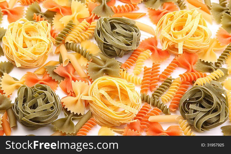 A different pasta in three colors on the white background.