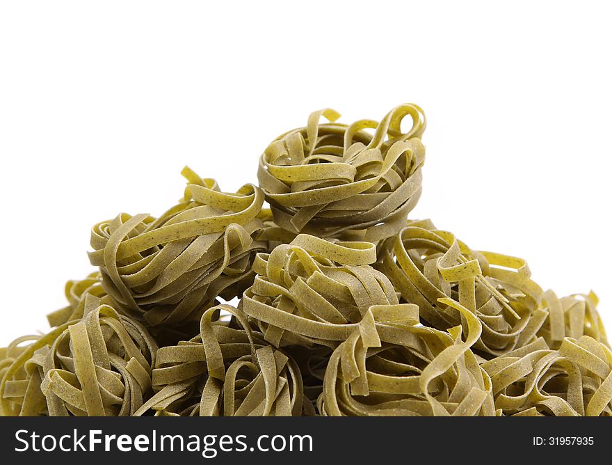Italian pasta (tagliatelle) with spinach on napkin, closeup. Italian pasta (tagliatelle) with spinach on napkin, closeup