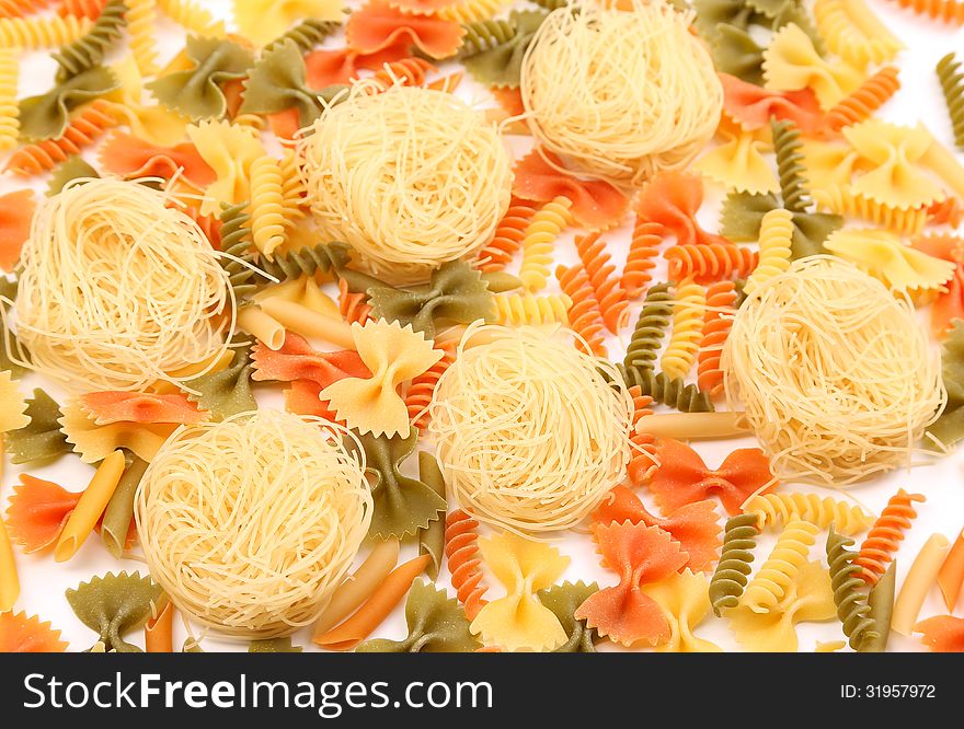 A different pasta in three colors close-up on the white background.