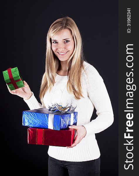 Attractive young woman with gift boxes, isolated on black. Attractive young woman with gift boxes, isolated on black.