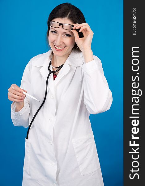 Happy doctor with a thermometer on a blue background. Happy doctor with a thermometer on a blue background