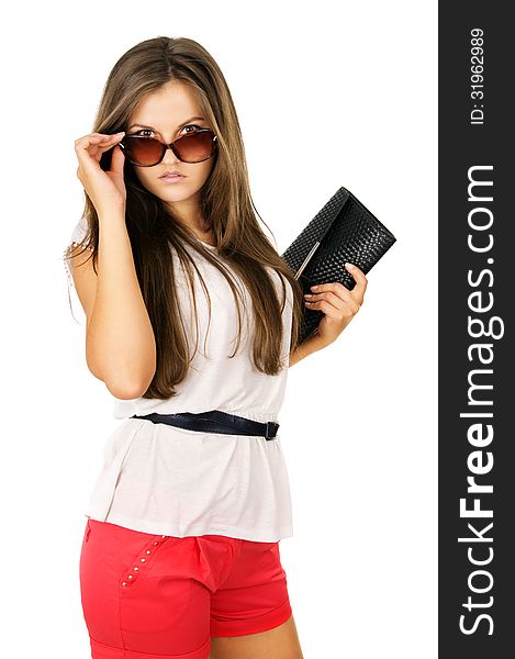 Glamor beautiful girl in sunglasses and clutches