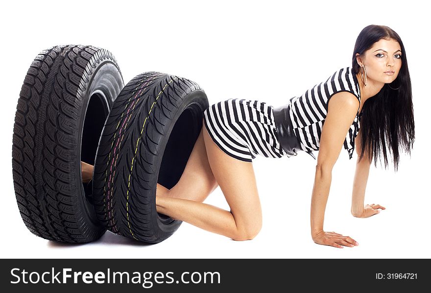 Young girl holds in her hand the car wheels, isolated on white. Young girl holds in her hand the car wheels, isolated on white.