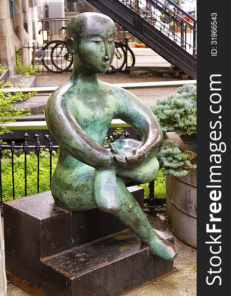 Bronze statue of a meditating person on steps. Bronze statue of a meditating person on steps