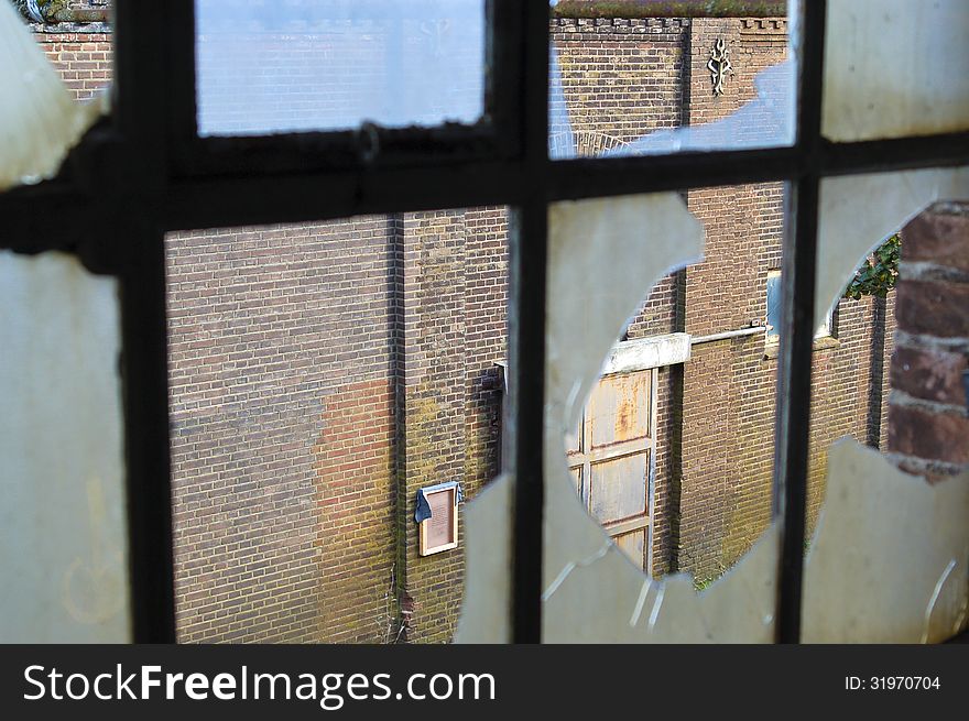 Broken window of an abandoned factory. Broken window of an abandoned factory