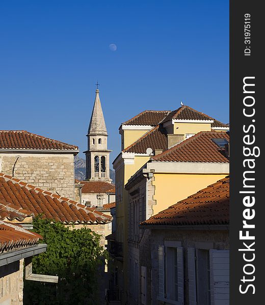 Early evening view to the Budva Old City with moon on the sky. Early evening view to the Budva Old City with moon on the sky