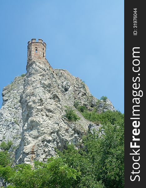 Maiden tower on sky background. Devin castle (864 - 15th century). Bratislava, Slovakia. Last fortifications built in the 17th century. Separated from the main castle, Maiden Tower balances perilously on a lone rock and has spawned countless legends concerning imprisoned lovelorn daughters leaping to their deaths. Maiden tower on sky background. Devin castle (864 - 15th century). Bratislava, Slovakia. Last fortifications built in the 17th century. Separated from the main castle, Maiden Tower balances perilously on a lone rock and has spawned countless legends concerning imprisoned lovelorn daughters leaping to their deaths