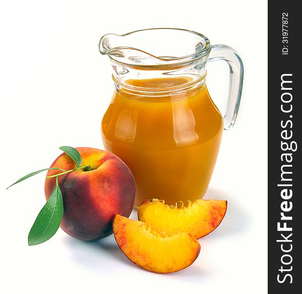 Peach juice in a jug and a glass of fruit. Peach juice in a jug and a glass of fruit