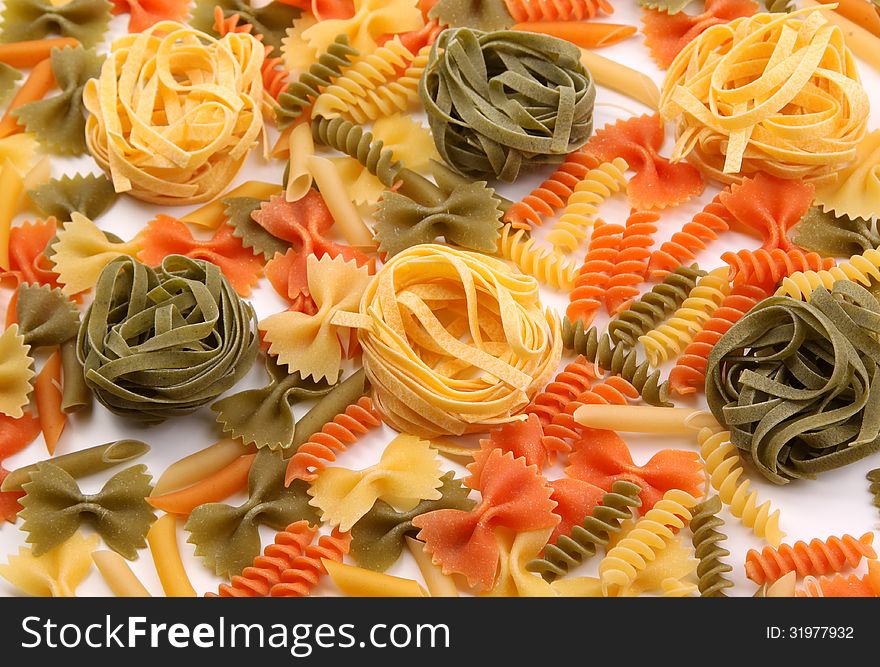 A different pasta in three colors on the white background. A different pasta in three colors on the white background.