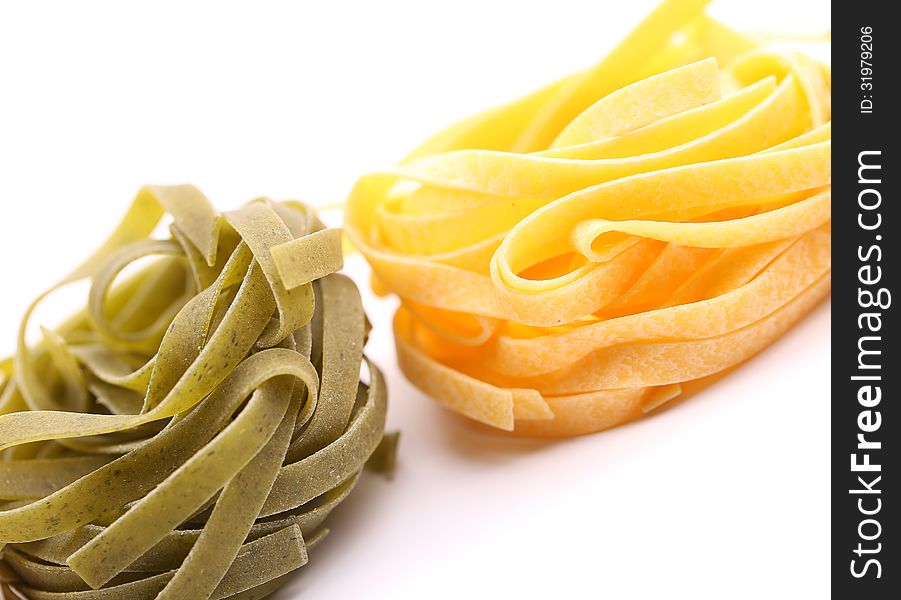Tagliatelle paglia e fieno tipycal italian pasta close-up on the white background