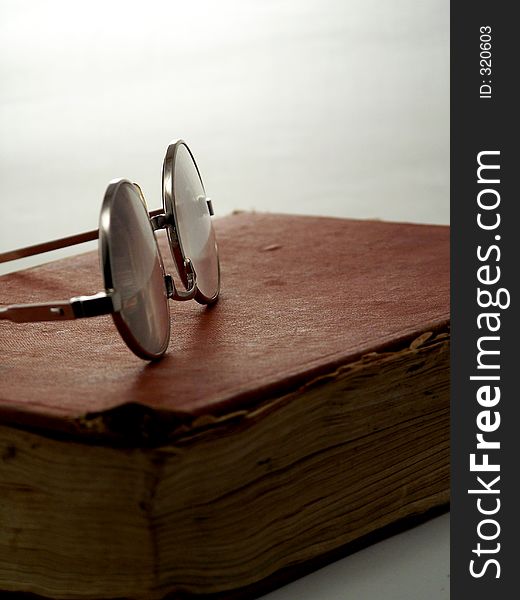 Eye glasses on vintage book. Eye glasses on vintage book.