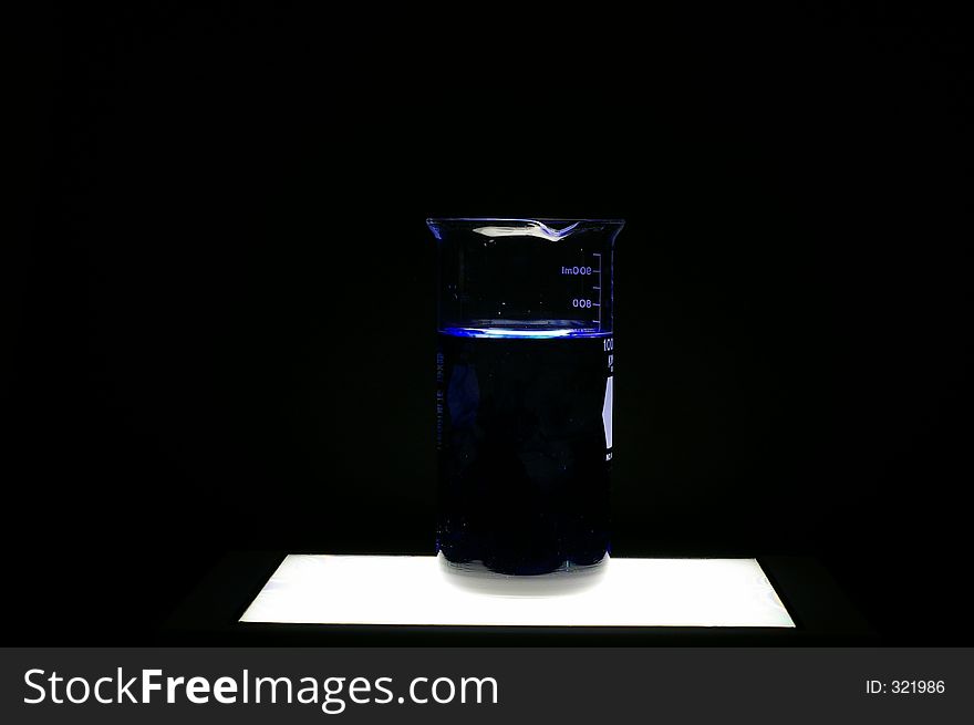 A beaker containing dark liquid
