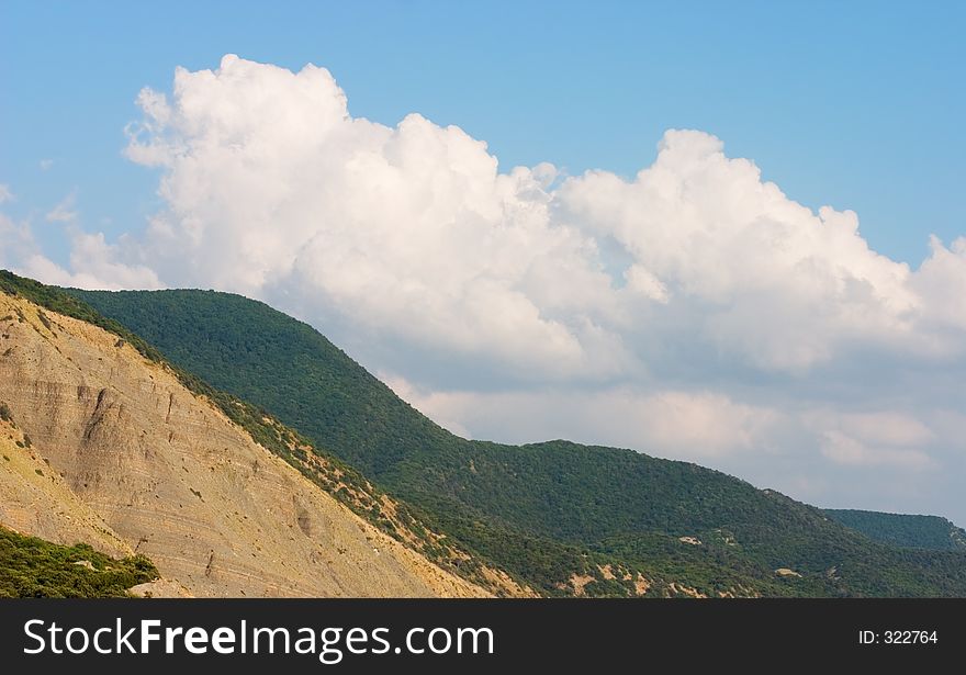 Hills with blue sky and white clouds on background. Hills with blue sky and white clouds on background