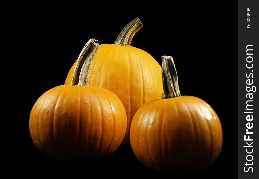 Three pumpkins isolated on black. Three pumpkins isolated on black