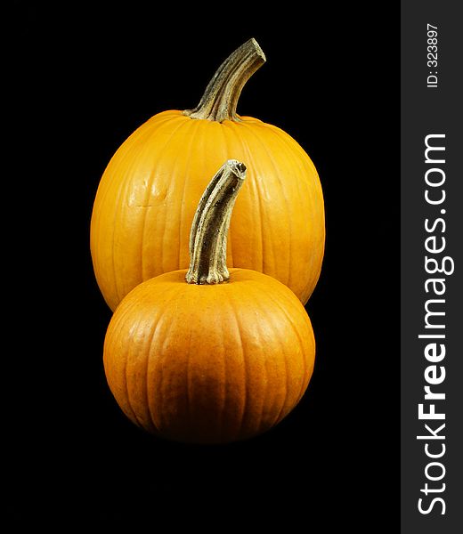 Two pumpkins isolated on black