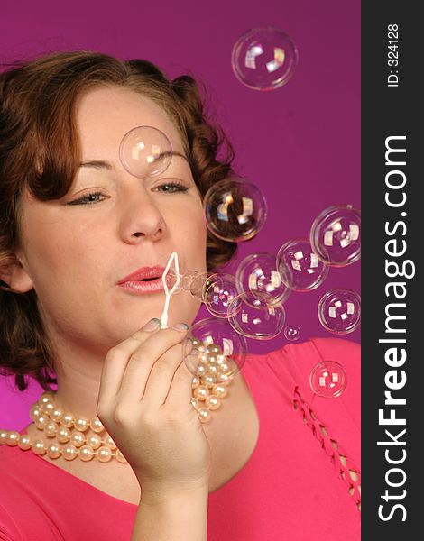 Close up of a girl blowing bubbles