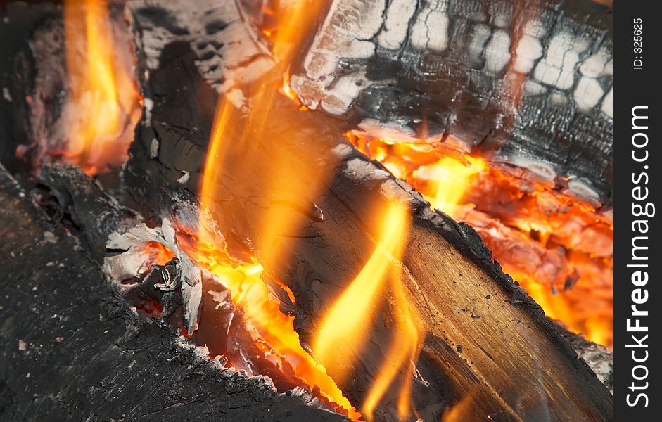 Texture of burning open fireplace with fire, flame, wood and embers