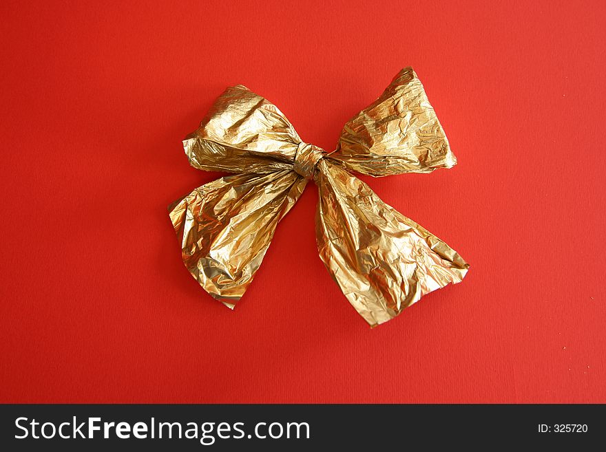 Golden ribbon on red background