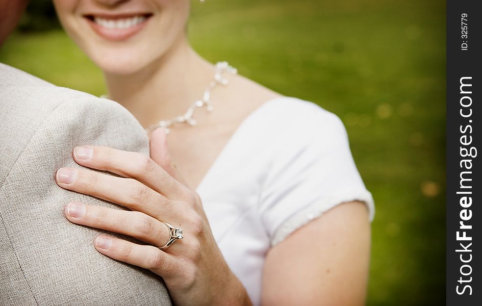 Woman smiles while hugging the groom. Woman smiles while hugging the groom