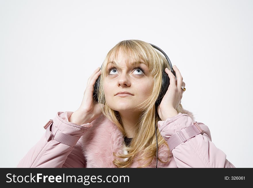 Girl with headphones on is looking up